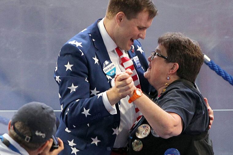 Two delegates dance during a break on the final day of the convention.