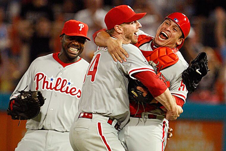 Phillies starting pitcher Roy Halladay celebrates with Carlos Ruiz in 2010. (Wilfredo Lee/AP)