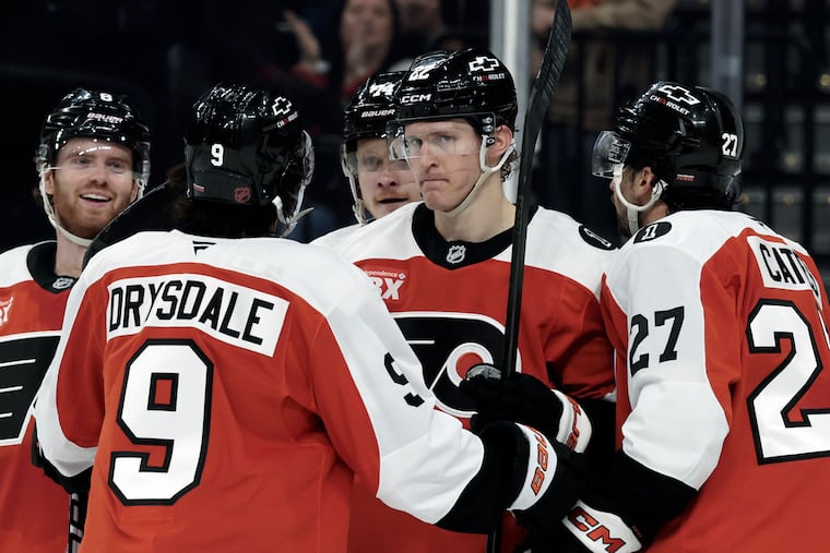 Flyers players celebrate Christian Dvorak's (center) second period goal to give the Flyers a 5-1 lead.