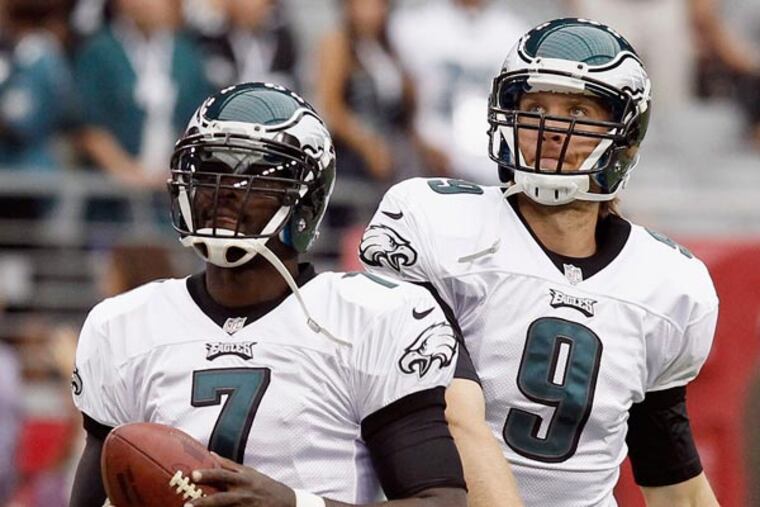 Michael Vick (7) and Nick Foles (9) warm up prior to an NFL football game against the Arizona Cardinals Sunday, Sept. 23, 2012, in Glendale, Ariz. (Ross D. Franklin/AP file)