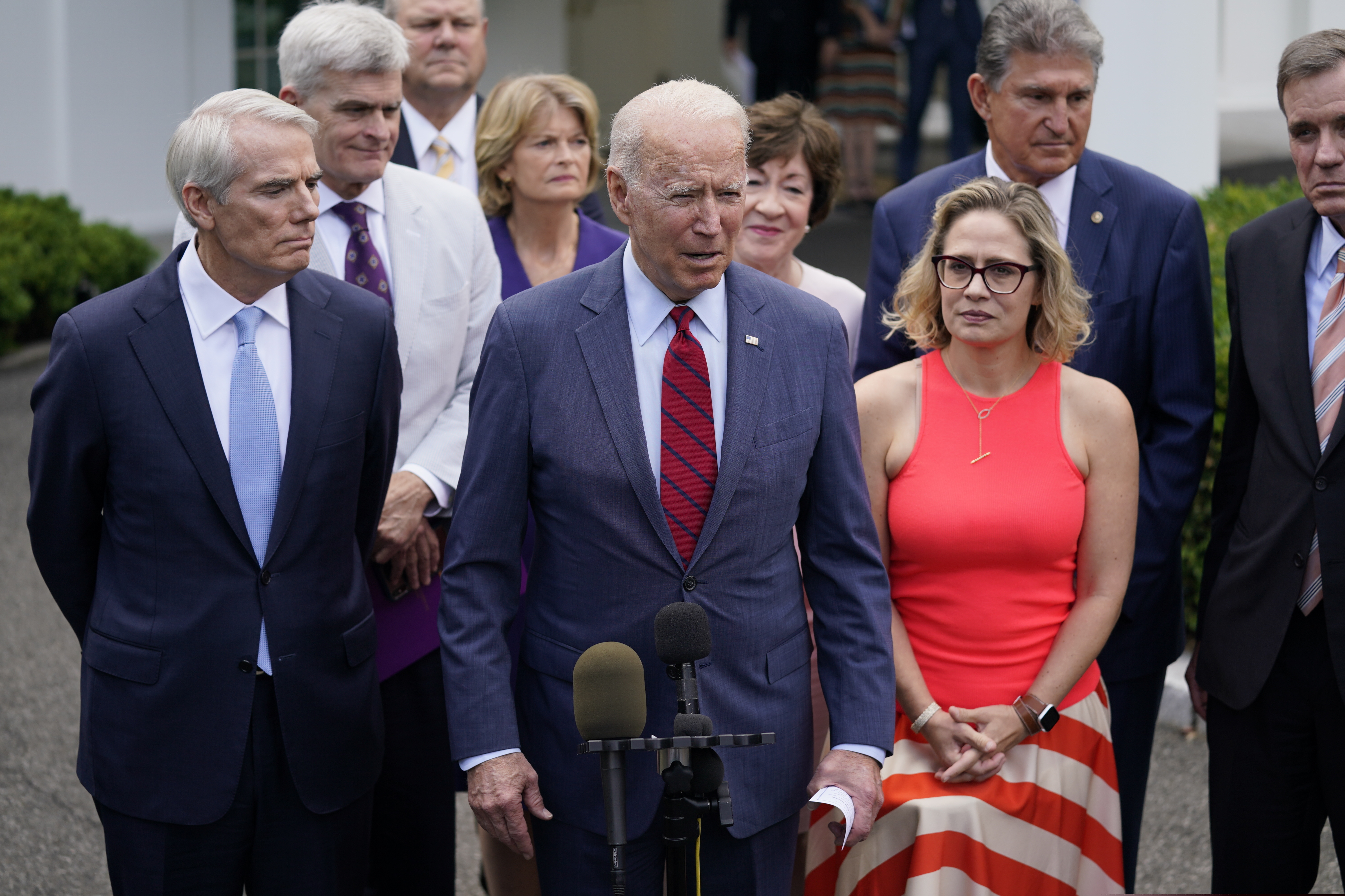 President Joe Biden, with a bipartisan group of Senators, speaks Thursday outside the White House in Washington.