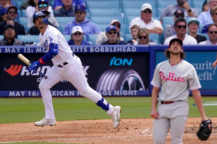Los Angeles Dodgers' Miguel Vargas, left, he's to first for a two-run home run as Philadelphia Phillies starting pitcher Aaron Nola watches during the fourth inning of a baseball game Wednesday, May 3, 2023, in Los Angeles. (AP Photo/Mark J. Terrill)