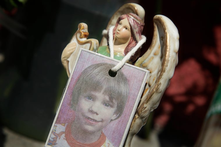 A photograph of Etan Patz hangs on an angel figurine, as part of a makeshift memorial in New York on May 28, 2012.
