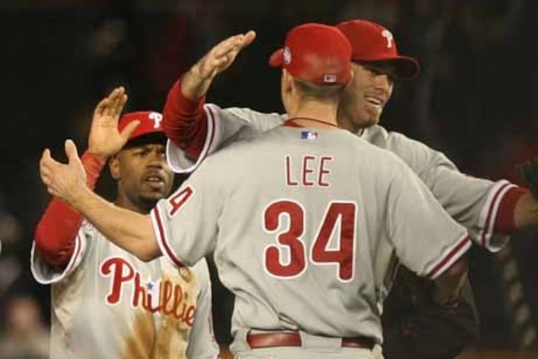 Cliff Lee getting congratulated by Jayson Werth as Jimmy Rollins waits his turn after Lee won the first game of the 2009 World Series.