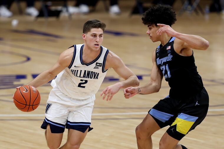 Collin Gillespie, left, of Villanova drives against D.J. Carton of Marquette during the second half on Feb. 10.