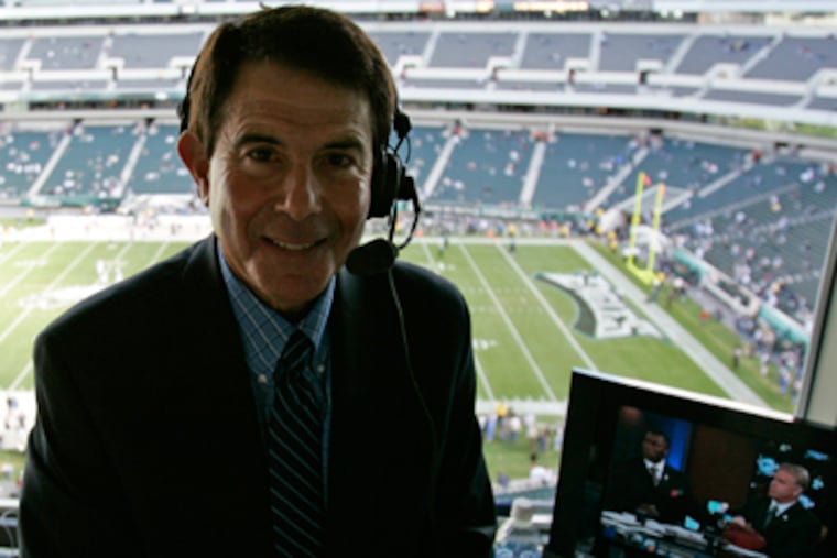 Eagles' play-by-play announcer sits in the booth before the start of a game. (AP Photo / Michael Perez)