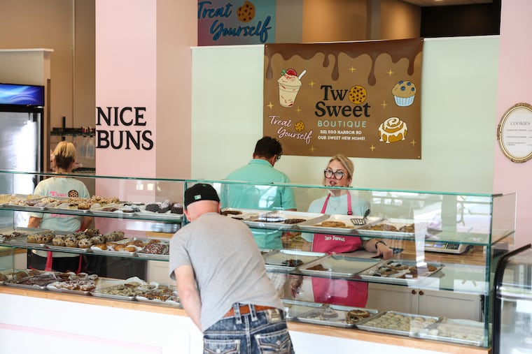 Michelle Cook (right) serves a customer at Two Sweet Boutique in July in Sewell, N.J.