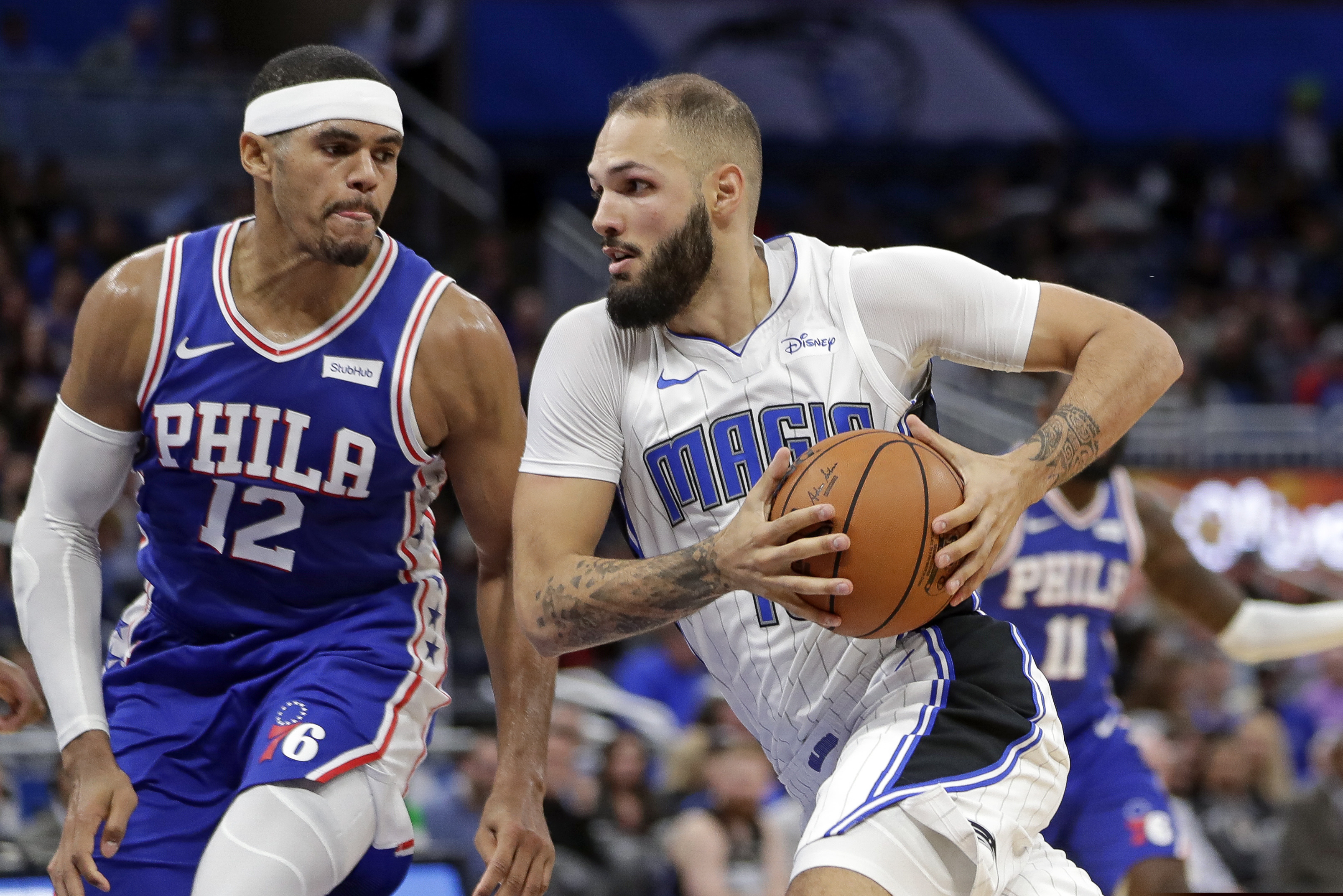 Orlando's Evan Fournier drives around the 76ers' Tobias Harris during the first half.