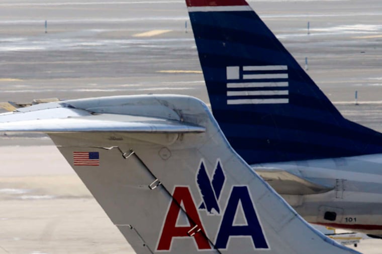 The Justice Department has settled a lawsuit that challenged the pending merger of American Airlines and US Airways. The latter is the dominant carrier at Philadelphia International Airport. (Matt Rourke / AP)