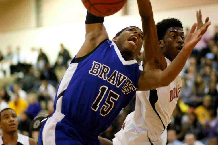 Williamstown's Julian Martin (left) is fouled as he goes up for a shot by Kingsway's Troy Jenkins, who later scored the winning layup as time expired.
