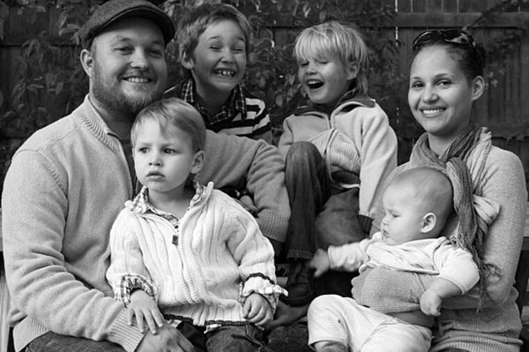 Edward Pyanov holds Luke, his wife, Maria, holds Lex, and between them are Liam (left) and Levi. The first three births were text-book easy, but Lex gave his mother a more difficult time.