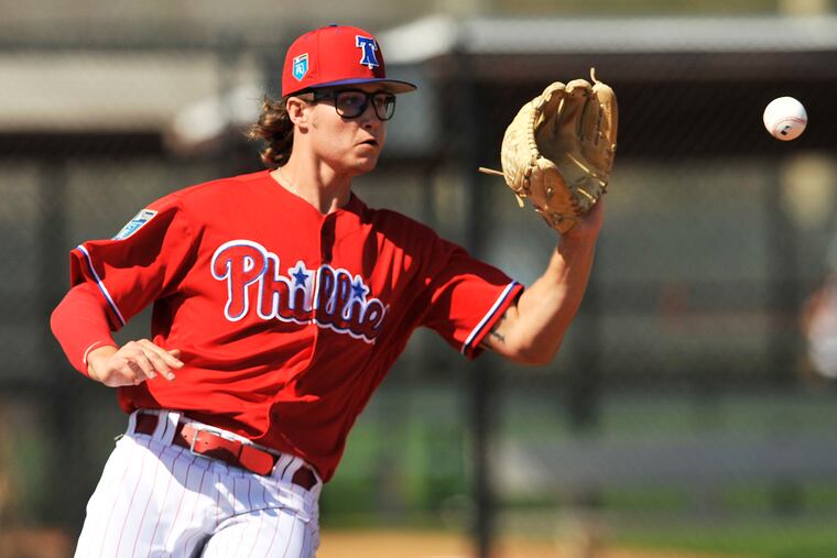 Philadelphia Phillies pitcher J.D. Hammer reaches for a throw to first base during workouts at the Phillies spring training complex Thursday, Feb. 15, 2018 in Clearwater, Fla.