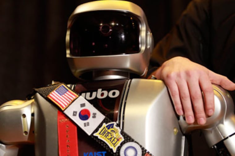 Handler Daniel M. Lofaro introduces Jaemi HUBO, one of seven adult-sized humanoid robots at Drexel University today during National Engineers Week. (DAVID SWANSON / Staff Photographer)