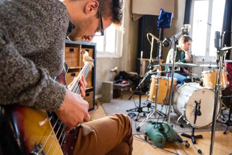 Night Panther's Christopher Radwanski worked out a few bass parts. He usually plays guitar and synthesizers in the band, but for the Shaking Through session, he switched to bass. (COLIN KERRIGAN / Philly.com)