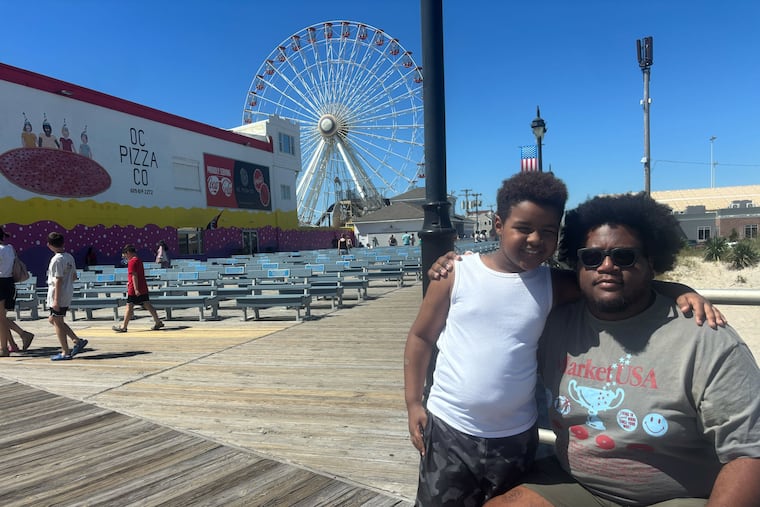 Jhan'marco Guichardo, 8, of Gloucester City, and his brother-in-law, Chris Sanchez, 27, of Philadelphia, outside the old Gillian's Wonderland Pier in Ocean City, N.J., on Saturday. On the last weekend of summer, Guichardo was full of ideas for reviving the amusement pier.