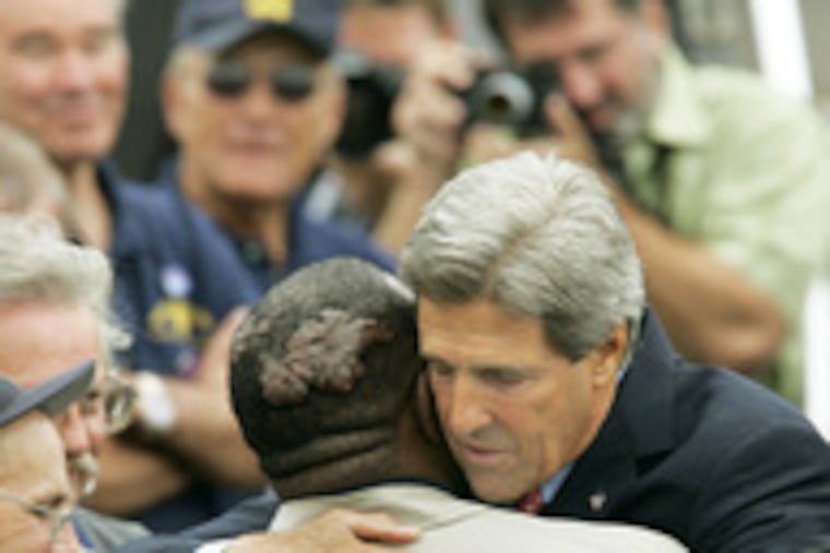 Comrades in arms hug. Democratic presidential candidate John Kerry heartily greets a Vietnam Swift Boat crewmate.