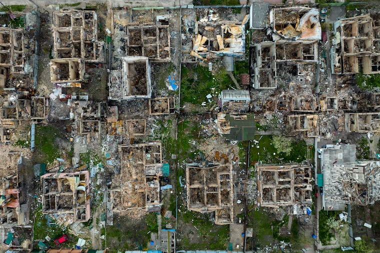 Destroyed houses are photographed in Irpin, on the outskirts of Kyiv, Ukraine, Saturday, April 30, 2022.