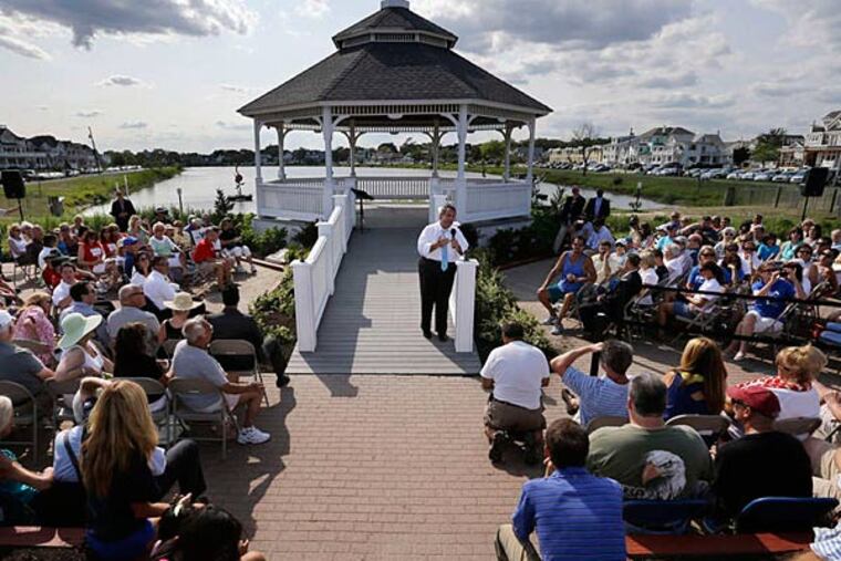 Gov. Christie continued his Shore talks with a town-hall meeting Wednesday at a gazebo near Belmar's beach. The crowd included many retired teachers and other state workers who held signs and wore shirts that said "Our Pain, Christie's Gain" - a play on the "No Pain, No Gain" title his staff has given this summer's push. (Mel Evans/AP)