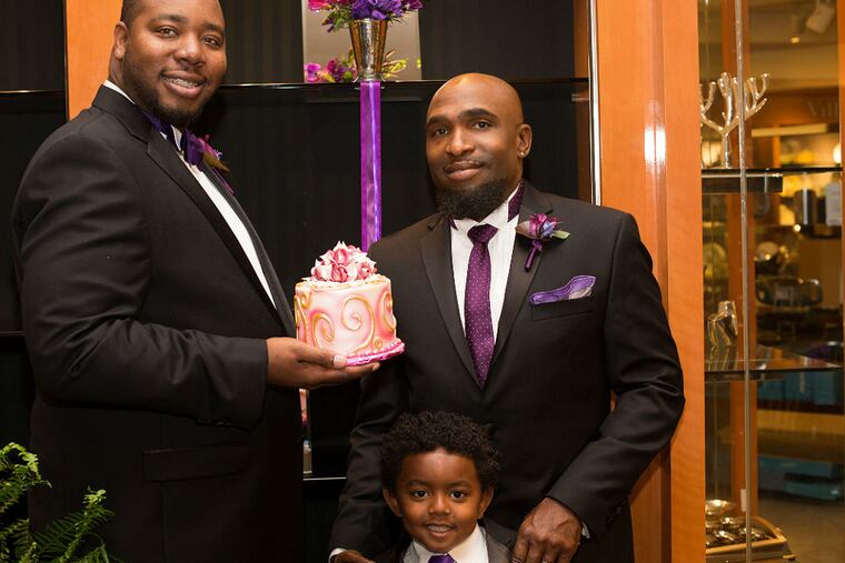 Jason Strong (left) and Anthony Henderson with their son, Marcelino. They were married in a Los Angeles-area Macy's. (Laura Palazzolo)