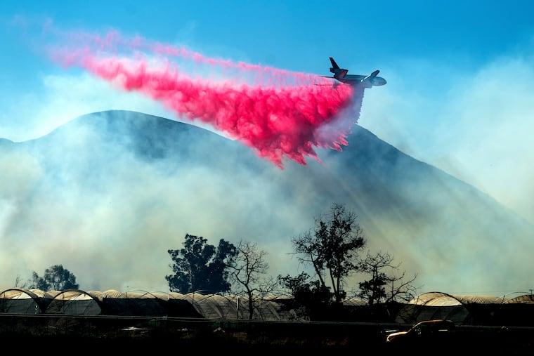 An air tanker drops retardant as the Maria Fire approaches Santa Paula, Calif., on Friday, Nov. 1, 2019. According to Ventura County Fire Department, the blaze has scorched more than 8,000 acres and destroyed at least two structures.