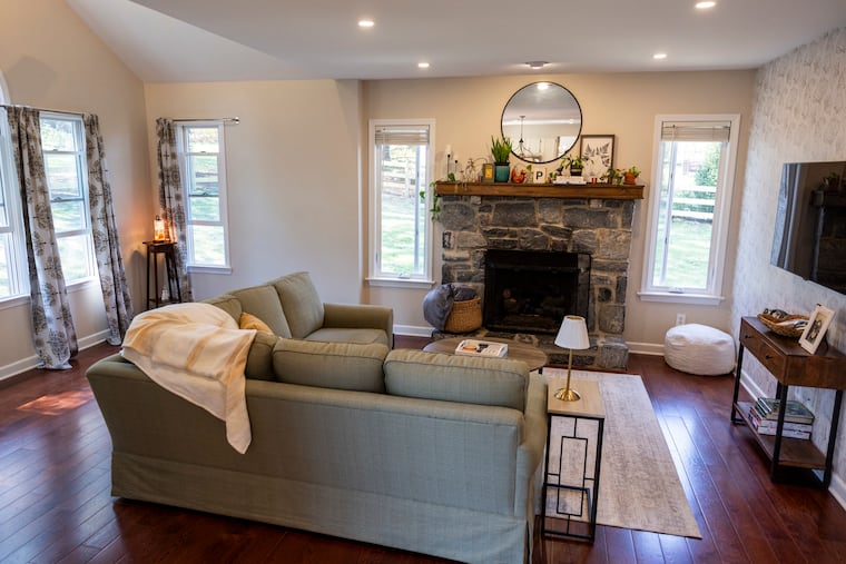 The living room has enough space for a sectional sofa and the fireplace keeps it cozy. 