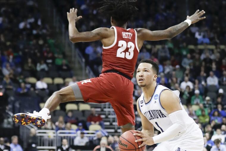 Villanova guard Jalen Brunson fakes his shot attempt past Alabama guard John Petty during the first-half in the second-round of the NCAA men's basketball tournament on Saturday, March 17, 2018 at PPG Paints Arena in Pittsburgh. YONG KIM / Staff Photographer
