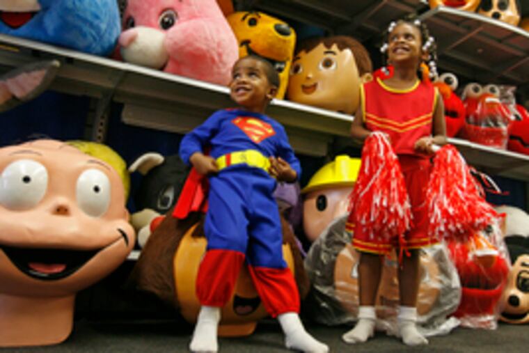 Derek Lee Porter Jr., 2, and sister Jessica, 4, model age-appropriate costumes at their parents' store, D&J Costumes in the Northeast.