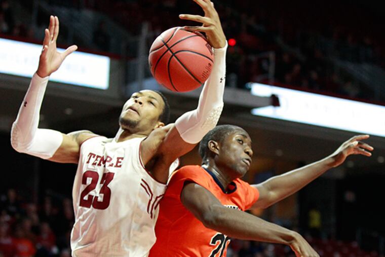 Temple's Devontae Watson, left, and Bucknell's Nana Foulland, right,
battle for a rebound. (Charles Fox/Staff Photographer)