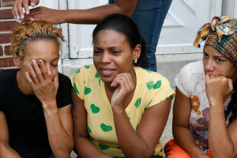 Another Camden family - that of Saad Brittingham, 17 - was in mourning yesterday. From left are Syreeta Brittingham, his mother; sister Shaheeda; and Apolonia Brittingham, a cousin.