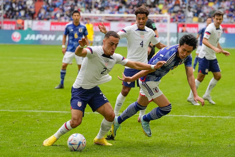 The United States' Sergino Dest (left) and Japan's Daichi Kamada fight for the ball during Friday's game.