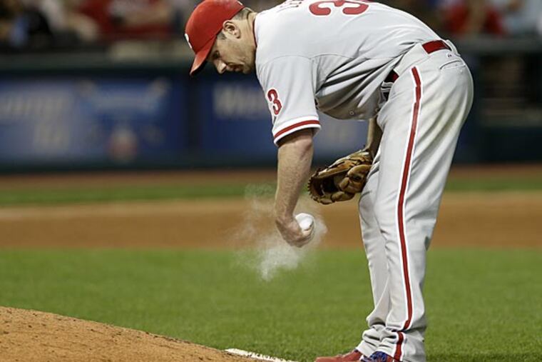 Philadelphia Phillies starting pitcher Cliff Lee works the rosin bag in the sixth inning of a baseball game against the Cleveland Indians, Wednesday, May 1, 2013, in Cleveland. (AP Photo/Tony Dejak)