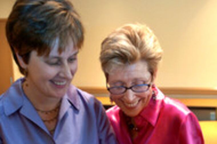 Sharing a moment after their civil-union ceremony in Collingswood are Carrie Winters (left) and Christina Ford.