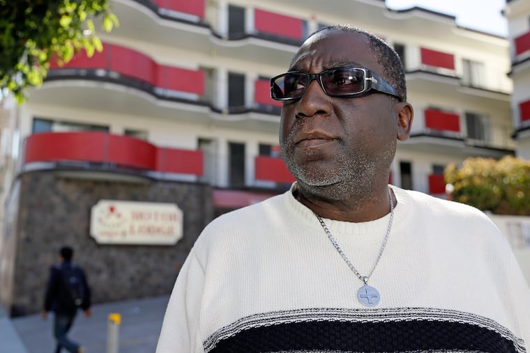 Yul Dorn, who lost his home to foreclosure, poses outside a motel near his office in San Francisco. Dorn and his wife raised their son and daughter in a two-story home crammed with family photos, one they bought in a historically African-American neighborhood in San Francisco more than two decades ago<br/>
Today, the couple is living in a motel after they were evicted last year, having lost a foreclosure battle.