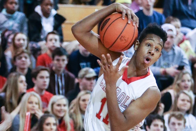 Carroll’s AJ Hoggard grabs a loose ball during the 1st quarter in Radnor, Friday, January 13, 2017.