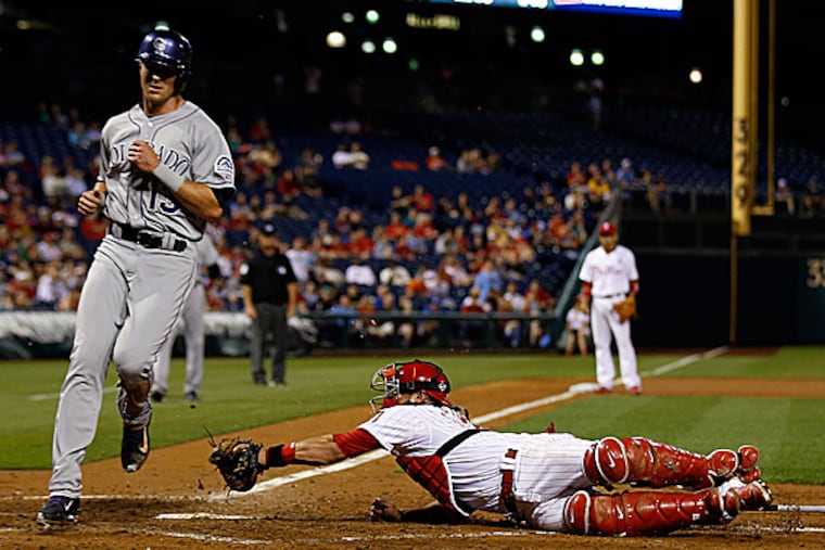 Phillies catcher Carlos Ruiz is late with the tag as the Rockies' Drew Stubbs scores in the fourth inning. (Yong Kim/Staff Photographer)