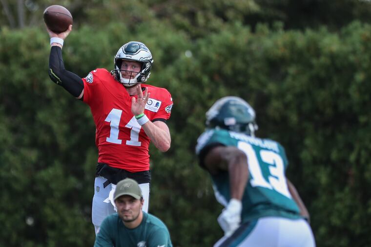 Eagles quarterback Carson Wentz throws a pass to wide receiver Nelson Agholor during a recent practice session at the NovaCare Complex.