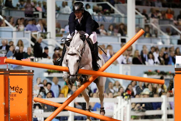 Country Boy with rider Andrew Kocher jump into the final jump-off fence during the Sapphire Grand Prix of Devon at the Devon Horse Show and Country Fair on Thursday.