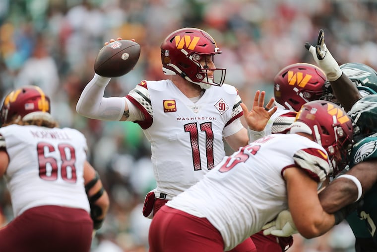Washington Commanders quarterback Carson Wentz throws the football against the Eagles during the third quarter at FedExField in Landover, MD, in September.
