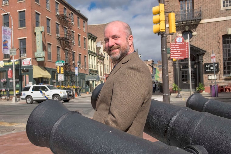 Philip Mead is surrounded by cannons from the Revolutionary War era in front of the museum at Third and Chestnut Streets.