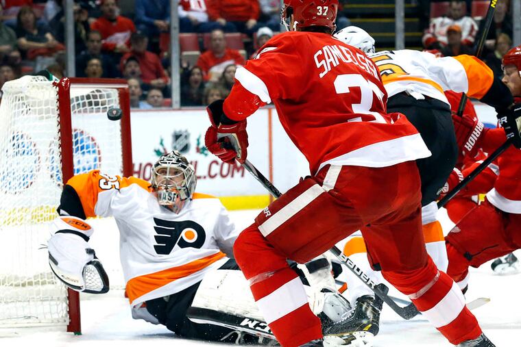 Flyers goalie Steve Mason stops a Detroit shot in the second period.