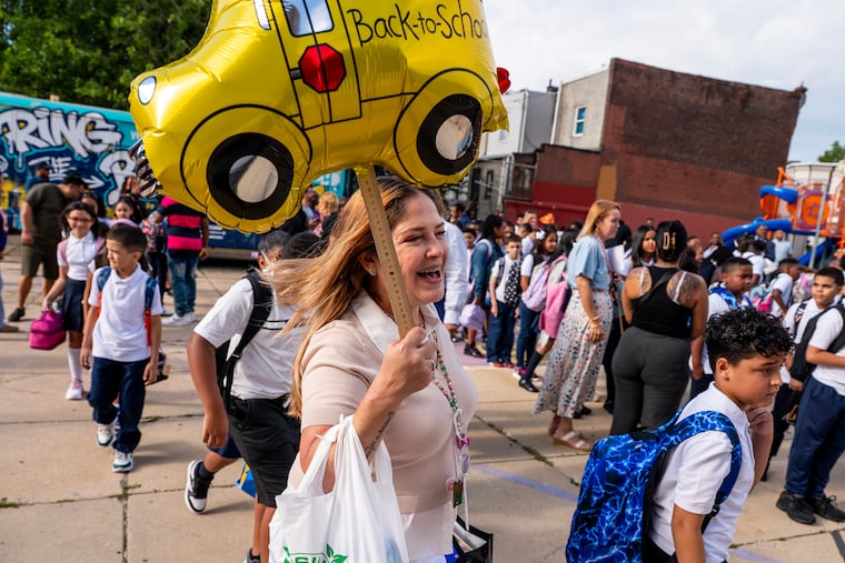 McClure Elementary fourth grade teacher Jesenia Rivera leads her students into class Monday, Aug. 24, 2026 on the first day of school in the Philadelphia School District.