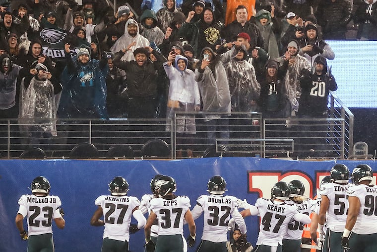 The Eagles' defense celebrates and poses for photos after an interception by Sidney Jones (22) in the fourth quarter.