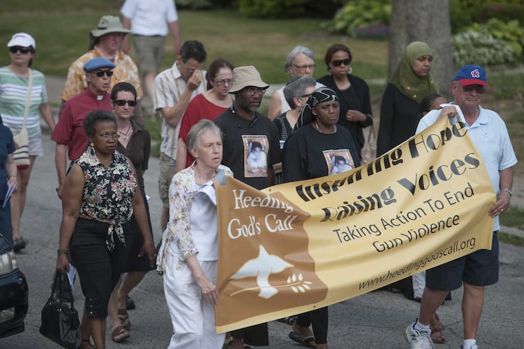 Members of Heeding God's Call, which seeks to end gun violence, marching toward a rally in May 2015 at the site where James Stuhlman was slain.