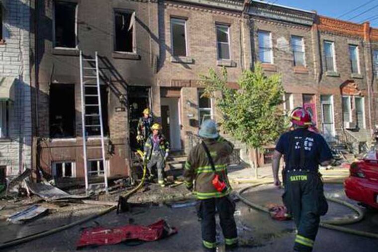 Firefighters respond to the scene of a blaze being investigated as an arson in South Philadelphia. (Alejandro A. Alvarez / Daily News)