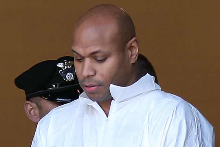 Radnor Township Police lead Sean Moses out to a waiting police van on March 2, 2015. ( DAVID MAIALETTI / Staff Photographer )