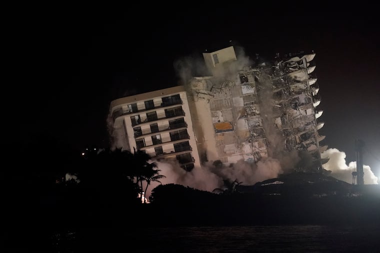 The damaged remaining structure at the Champlain Towers South condo building collapses in a controlled demolition, Sunday, July 4, 2021, in Surfside, Fla. The decision to demolish the Surfside building came after concerns mounted that the damaged structure was at risk of falling, endangering the crews below and preventing them from operating in some areas.