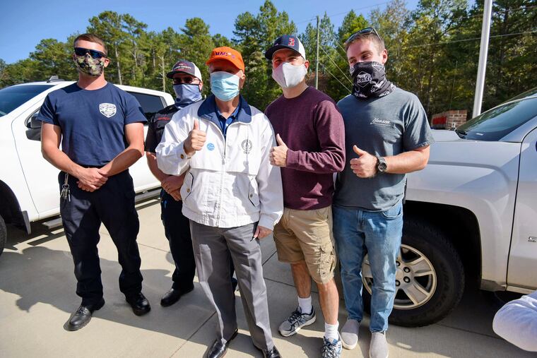 Republican U.S. Sen. Lindsey Graham, center, poses for a photo with Fire Chief Kevin Christenbury, second from right, and fellow firefighters after voting.