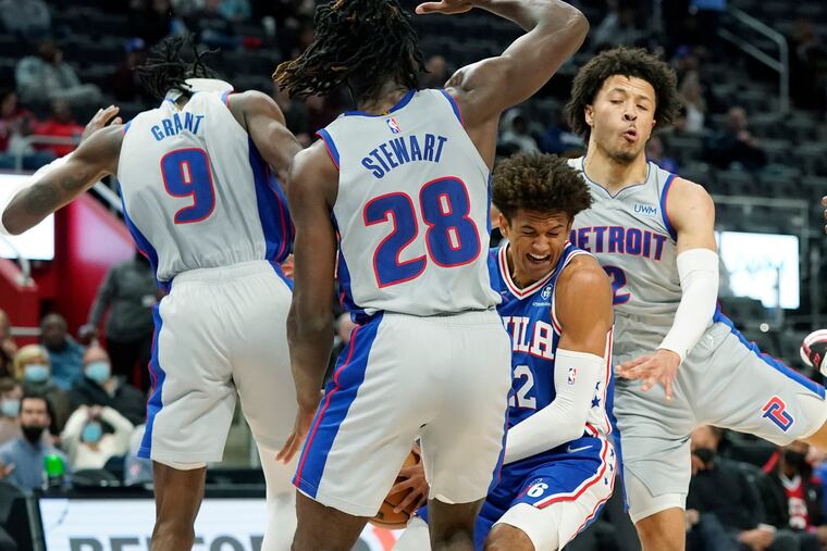 76ers guard Matisse Thybulle is surrounded by Detroit Pistons forward Jerami Grant, center Isaiah Stewart and guard Cade Cunningham during the second half.