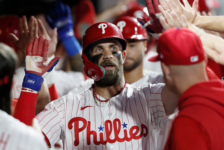 Phillies Bryce Harper high-fives teammates after hitting a two-run home run in the sixth inning against the St. Louis Cardinals at Citizens Bank Park in Philadelphia on Saturday, August 22, 2026.