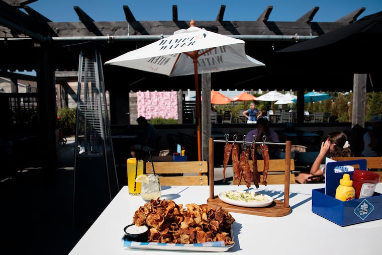 The Hanging Candied Bacon served over grits and Gully’s Blooming Potato at Gully's in Avalon, NJ.